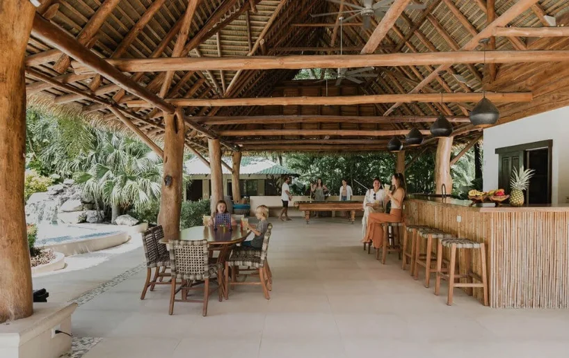 The open-air pavilion with dining tables and a bamboo bar